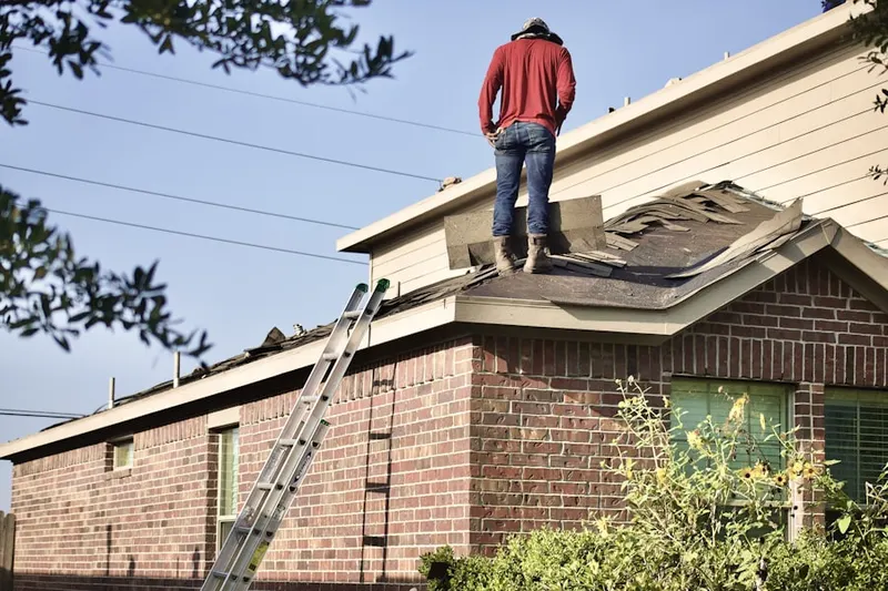Professional roofer working on a residential roof in Oliphants Mills